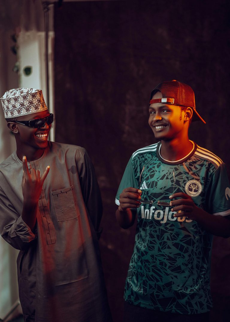 Two young men sharing a joyful moment, expressing friendship and happiness indoors.